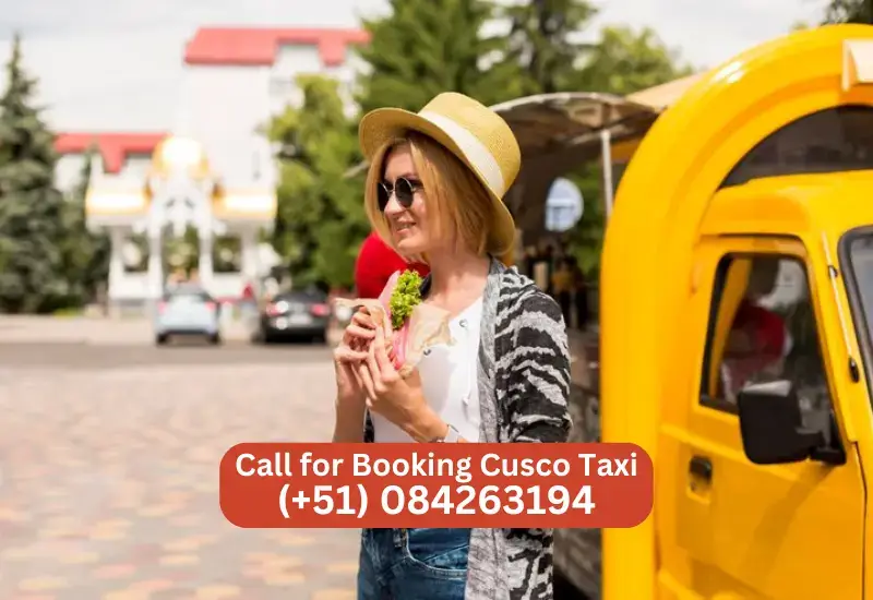 Woman with a sandwich standing in front of Cusco Taxi