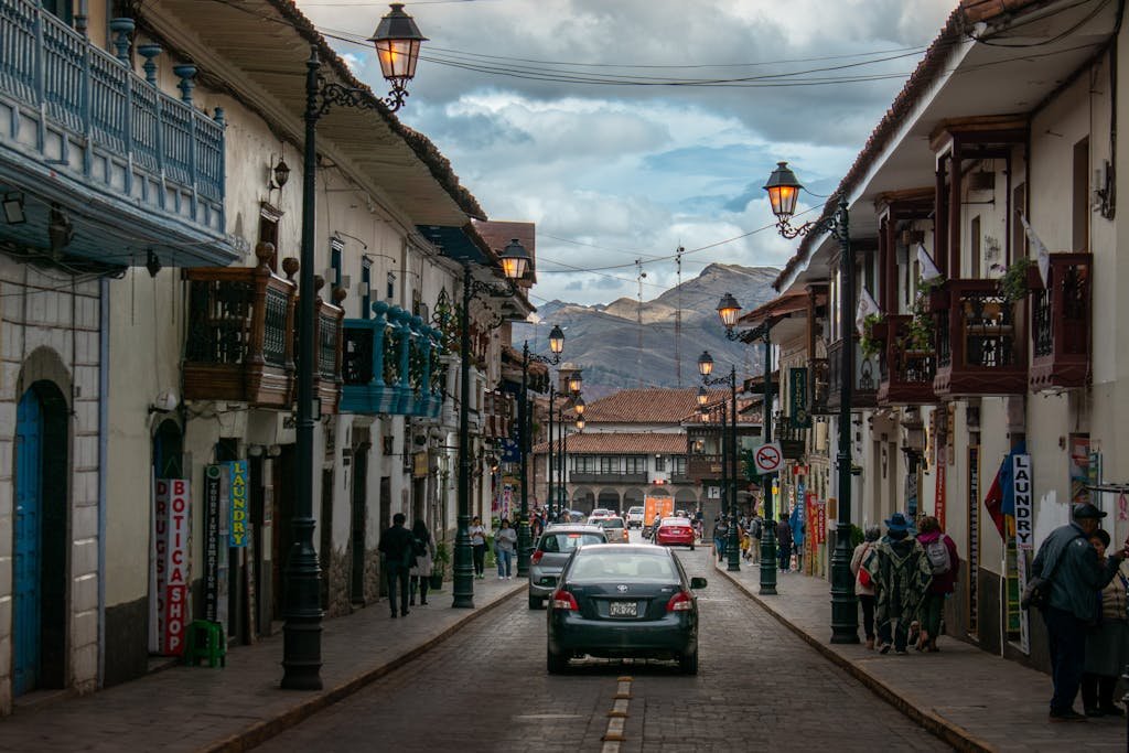 A bustling street scene in historic Cusco, Peru, featuring colonial architecture.